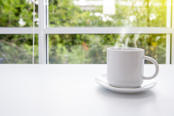 Hot coffee on old table with blur background. Coffee cup on the table in the morning.