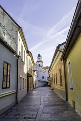 Narrow colorful Town Street with Church Tower in the Background