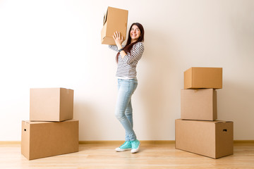 Image of young woman among cardboard boxes