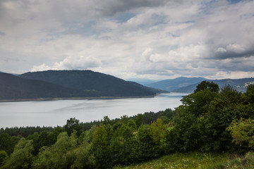 Fototapeta na wymiar Cloudy landscape view from Lake Bicaz in Romania