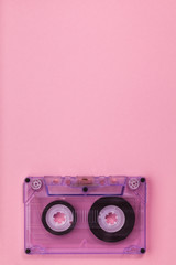 Compact audio tape cassette on pink background