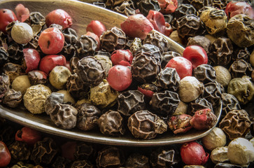 Red peppercorns with silver spoon