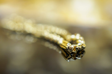 Luxury gold Jewelry bracelet with reflection on black background