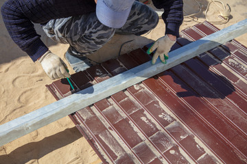 A man makes a fence of metal