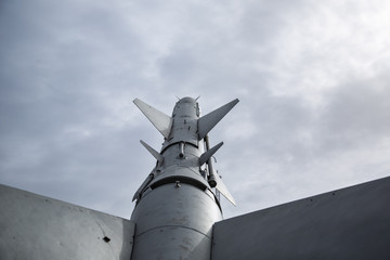 Old rocket missile on grey sky background