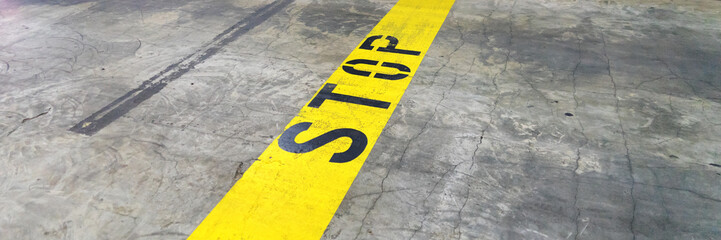 Yellow line with text STOP in the underground car park