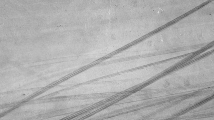 Aerial top view background with skid marks on race track.