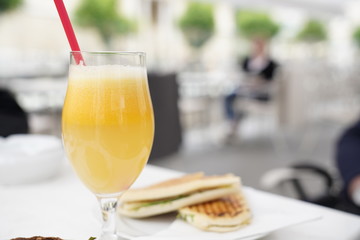 Fresh orange juice in a glass for breakfast on a white table