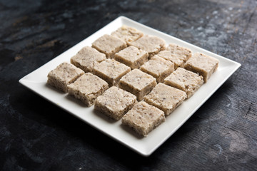 Barley water in glass bowl with spoon and raw and cooked pearl barley wheat/seeds. selective focus