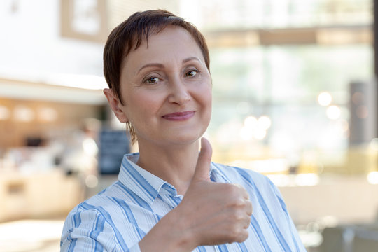 Woman giving  thumbs up, the thumb sign of approval