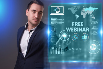 Business, Technology, Internet and network concept. Young businessman working on a virtual screen of the future and sees the inscription: Free webinar