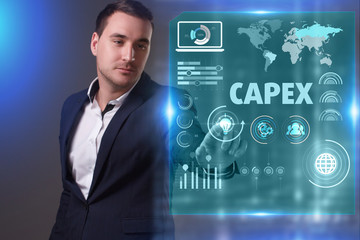 Business, Technology, Internet and network concept. Young businessman working on a virtual screen of the future and sees the inscription: Capex