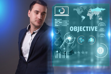 Business, Technology, Internet and network concept. Young businessman working on a virtual screen of the future and sees the inscription: Objective