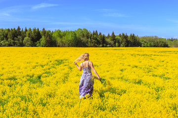 Girl  running  across the yellow field.