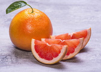 Grapefruit whole, and slice, juicy ripe isolated on a gray background