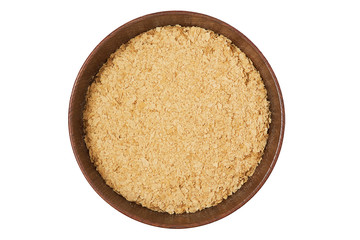 Nutritional brewers yeast flakes in wooden bowl isolated on white background. Top view