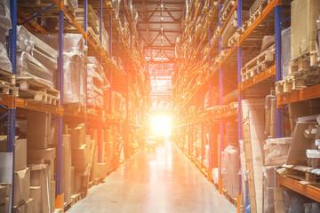 Large Logistics hangar warehouse with lots shelves or racks with pallets of goods. Industrial shipping and cargo delivery, sunlight effect