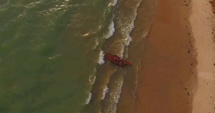 RIO DO FOGO, BRAZIL - JANUARY 5, 2018: Aerial view of fishmongers in Jangadas, small traditional boats on the beach of Rio do Fogo, Brazil