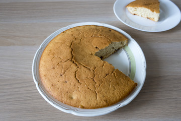 A beautiful and mouth-watering homemade cake close-up and a slice of cake.