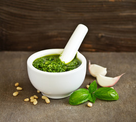 Homemade pesto in a white marble mortar.