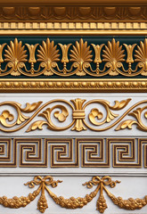 A set of the stucco molding of different styles covered with gold for decoration of internal space...