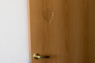 Broken door with golden handle and lock, side view