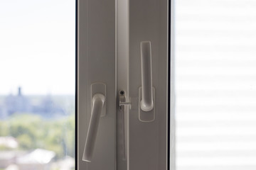 Plastic window and plastic window handles, blurred view from the window