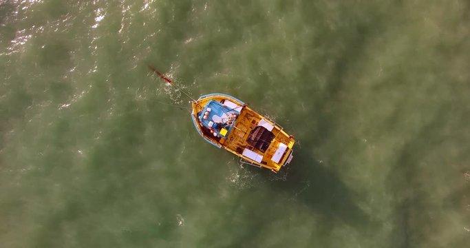 Aerial view of traditional fishing boat moored in the turquoise sea of Rio do Fogo, Brazil.