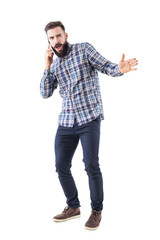 Angry bearded adult man yelling on the mobile phone gesticulating with hand. Full body isolated on white background. 