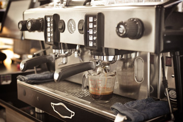Close up barista hands making coffee by machine in coffee cafe.