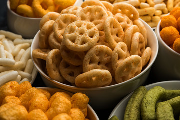 Kaju Katli is a Diamond shape Indian sweet made using cashew sugar and mava, served in a plate or bowl over moody background. selective focus