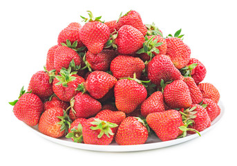 Pile of fresh red strawberry on a white plate isolated