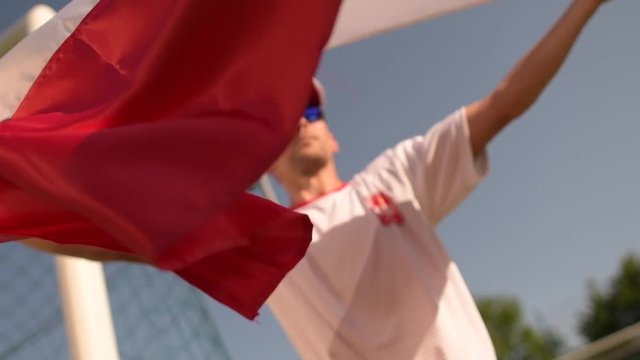 National Flag of Poland in Hands of Polish Sports Fan in Slow Motion