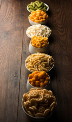 Kaju Katli is a Diamond shape Indian sweet made using cashew sugar and mava, served in a plate or bowl over moody background. selective focus