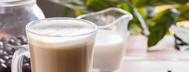 Cup of hot coffee latte beverages with donut glazed