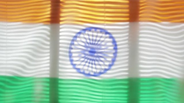 Flag of India is moving at wide jalousie window