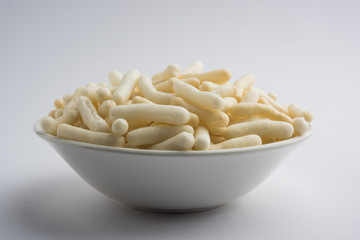 Kaju Katli is a Diamond shape Indian sweet made using cashew sugar and mava, served in a plate or bowl over moody background. selective focus