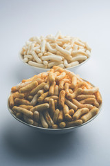 Kaju Katli is a Diamond shape Indian sweet made using cashew sugar and mava, served in a plate or bowl over moody background. selective focus