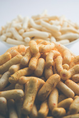 Kaju Katli is a Diamond shape Indian sweet made using cashew sugar and mava, served in a plate or bowl over moody background. selective focus