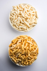 Kaju Katli is a Diamond shape Indian sweet made using cashew sugar and mava, served in a plate or bowl over moody background. selective focus