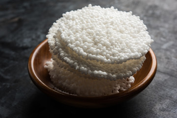 Indian food - Aloo curry masala. Potato cooked with spices and herbs in a tomato curry. served in a bowl over moody background. selective focus