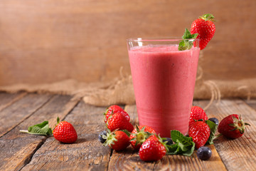 red smoothie on wood background
