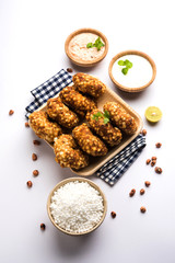 Sabudana vada or Sago fried cake served with peanut chutney over moody background, popular fasting recipe from India. 