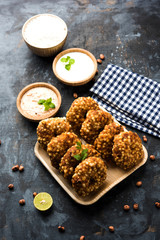 Sabudana vada or Sago fried cake served with peanut chutney over moody background, popular fasting recipe from India. 