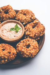 Sabudana vada or Sago fried cake served with peanut chutney over moody background, popular fasting recipe from India. 