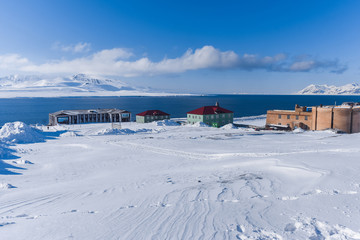 Landscape of the Russian city of Barentsburg on the Spitsbergen archipelago in the winter in the Arctic In sunny weather and blue sky