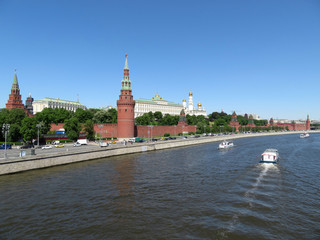 Tourist boats on the Moscow river on the background of the Kremlin towers. Kremlin embankment in summer, russian tourist landmark