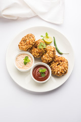 Paneer Butter Masala also known as Panir  makhani or makhanwala. served in a ceramic or terracotta bowl with fresh cream and coriander. Isolated over colourful moody background. selective focus