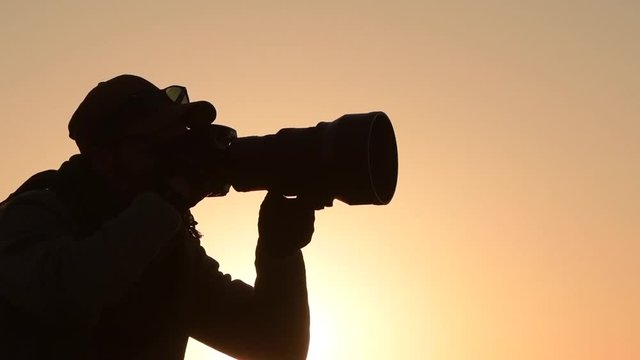 Nature Photographer Taking Pictures at the Sunset. Panoramic Photo. Slow Motion Footage