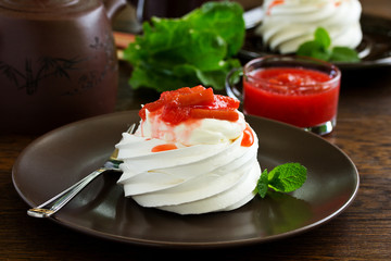 Dessert of meringue with rhubarb and mint sauce.